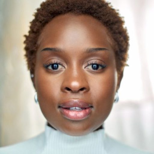 Ntobizodwa Ndlovu looks to camera, standing in front of a neutral background and wearing a white turtle neck jumper