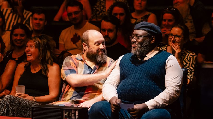 Jonny Donahoe shares a moment with an audience member during a performance of Every Brilliant Thing